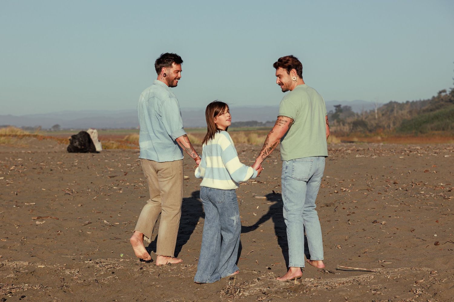 Family of four walking together along a Northern California beach during an outdoor family photography session.