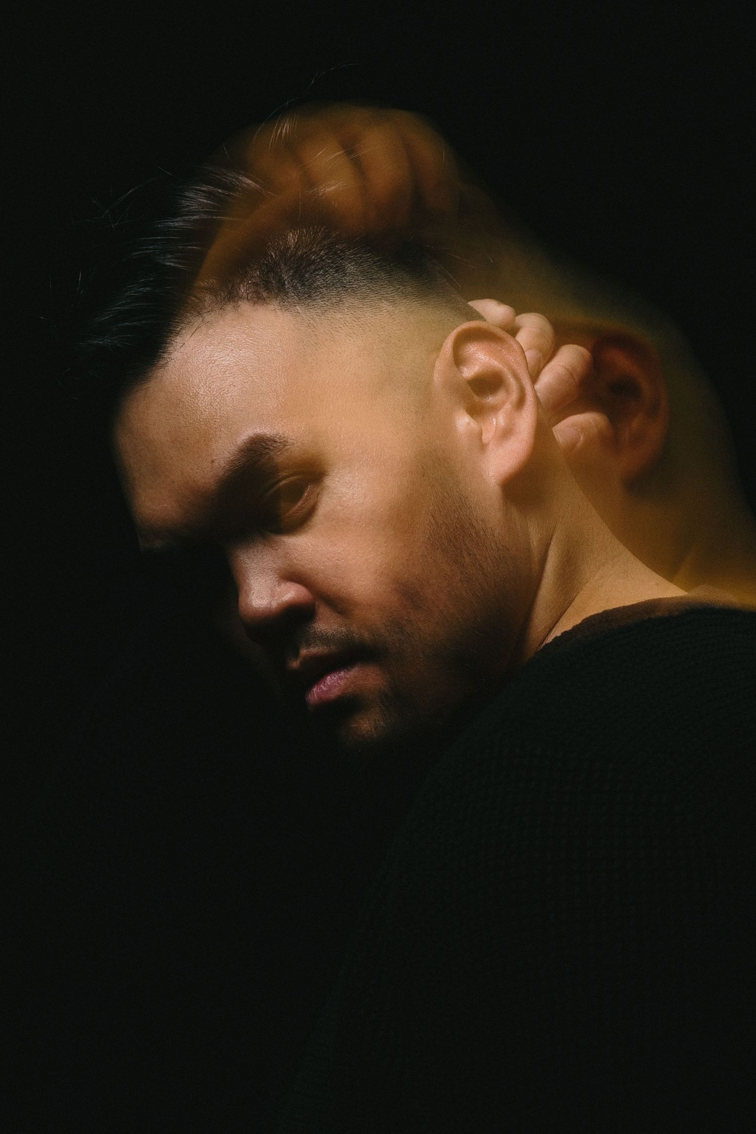 Editorial self-portrait of Bay Area photographer RyanVincent Alvarez in dramatic studio lighting.