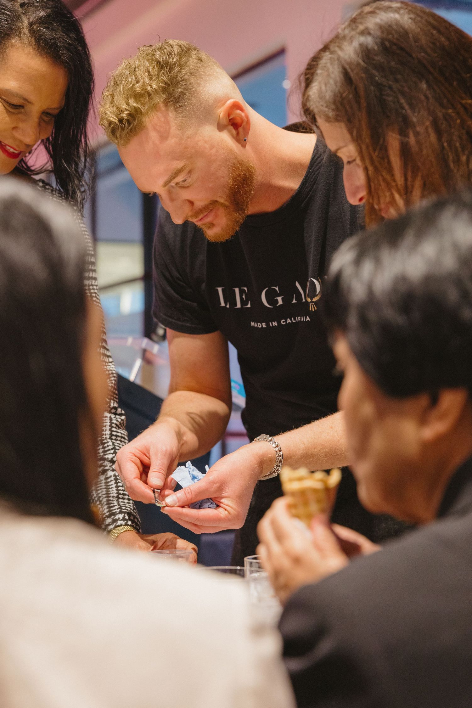 Brand storytelling photography capturing participants during a hands-on candle-making workshop.