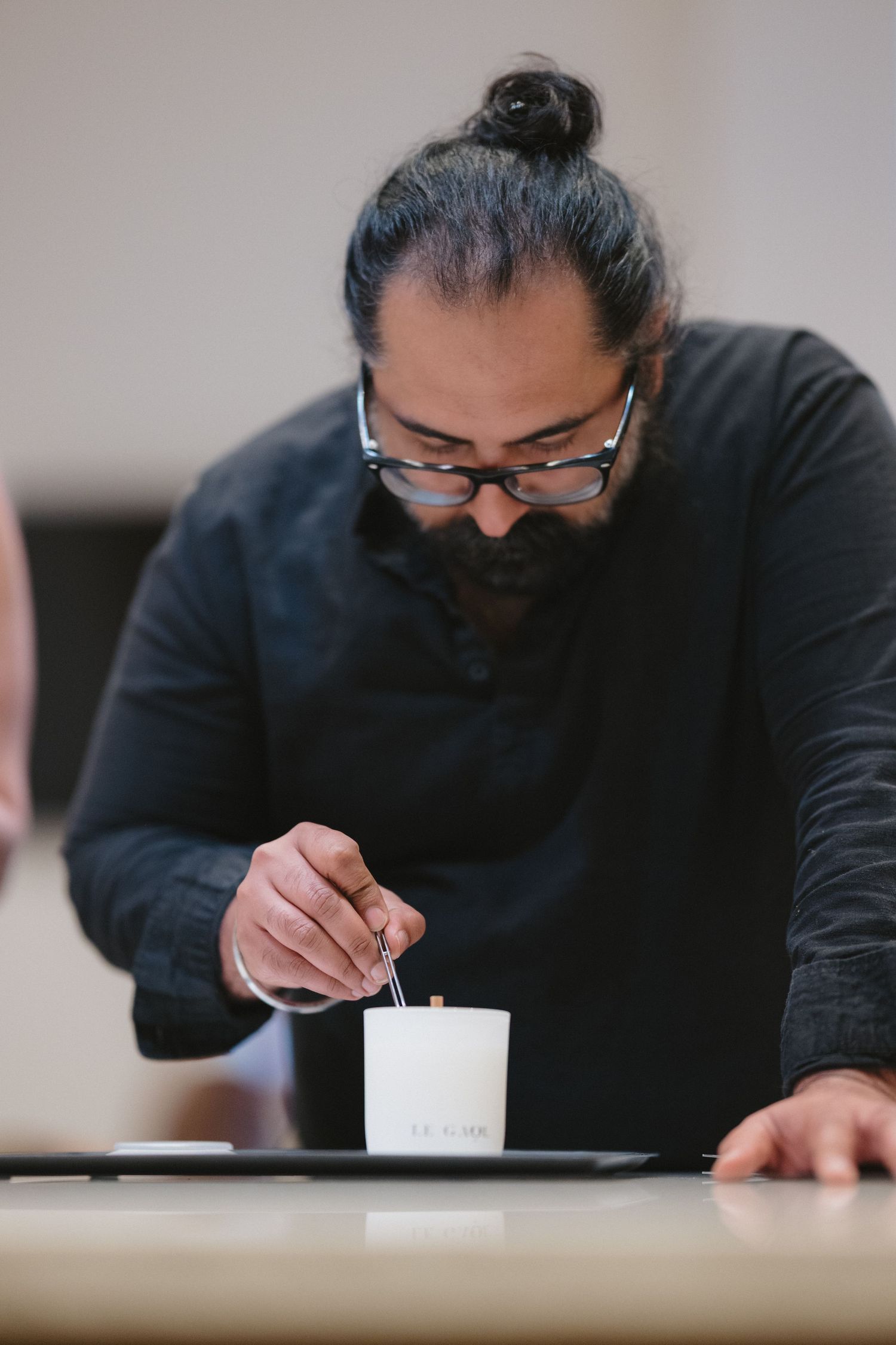 Artisan hand-pouring a candle during a fragrance workshop photographed in the San Francisco Bay Area.