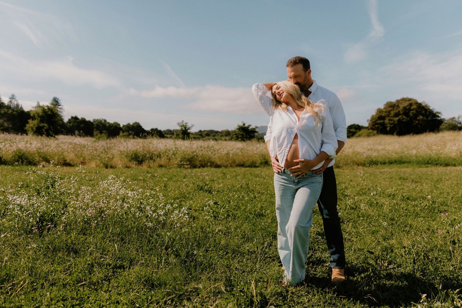Expecting couple embracing in a golden hour glow during a maternity photography session at Filoli Gardens.