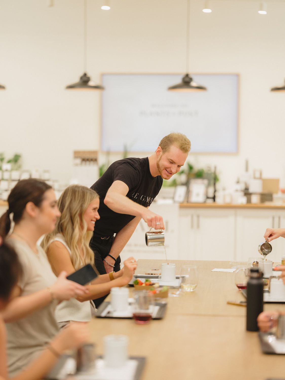 Workshop host guiding participants through a candle-making experience at a community fragrance workshop in the San Francisco Bay Area.