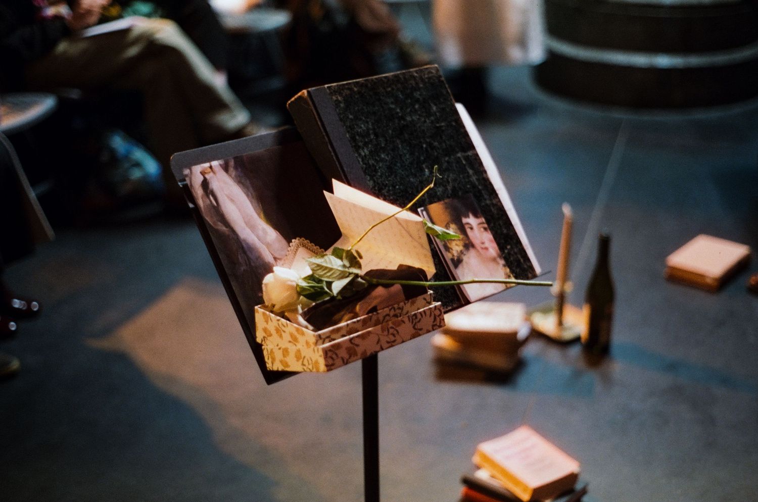 A colored 35mm film of a music stand with music sheet and white rose