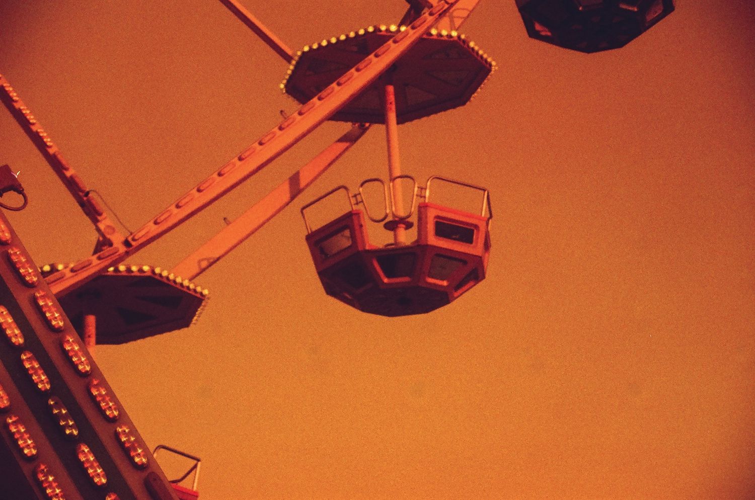 A colored close-up 35mm film of the ferris wheel at the funfair