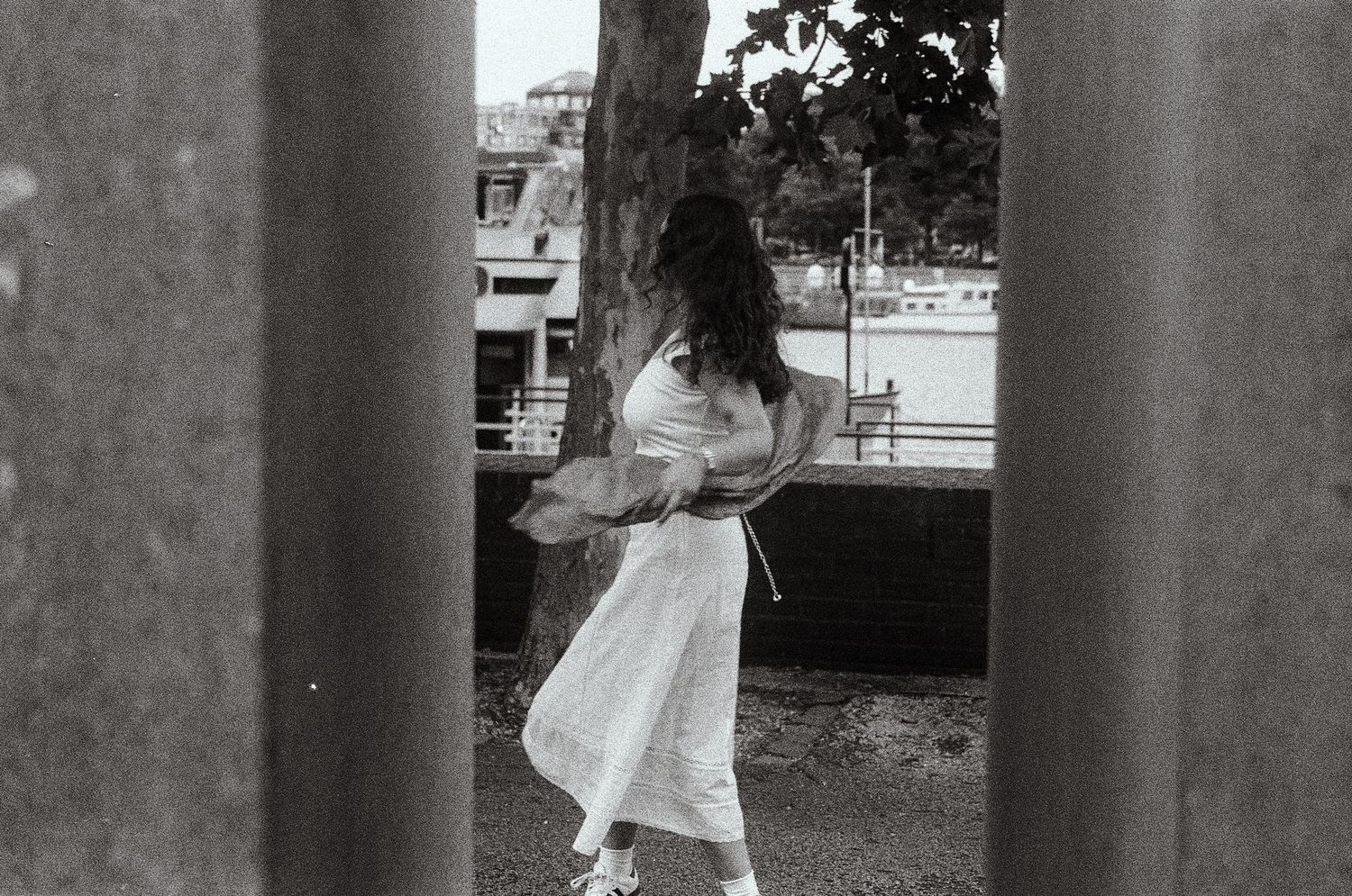 Black and white portrait 35mm film of a woman dancing between two walls