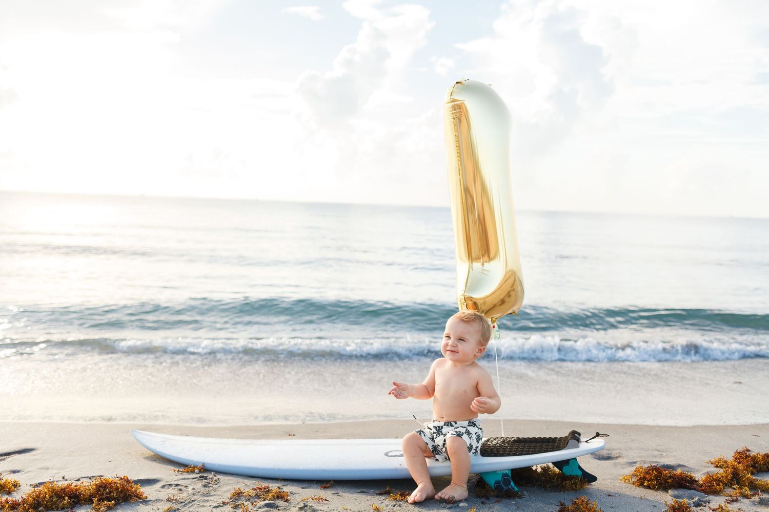 Baby's one year old birthday photoshoot on the beach. Milestone photoshoot session