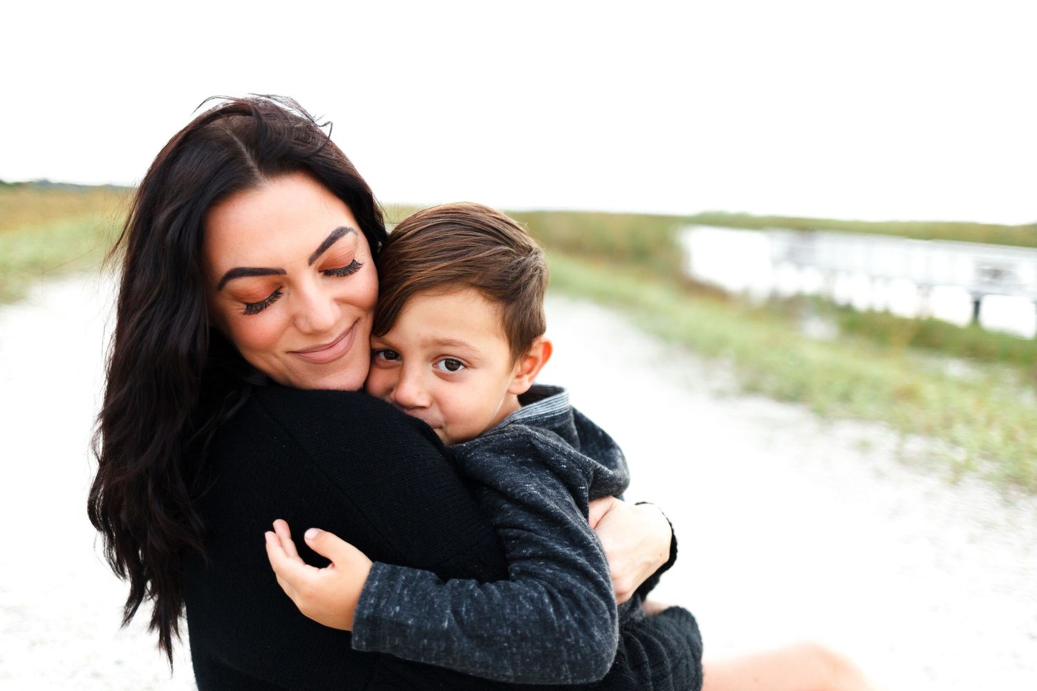 mom holding son during mommy and me photoshoot in boynton beach