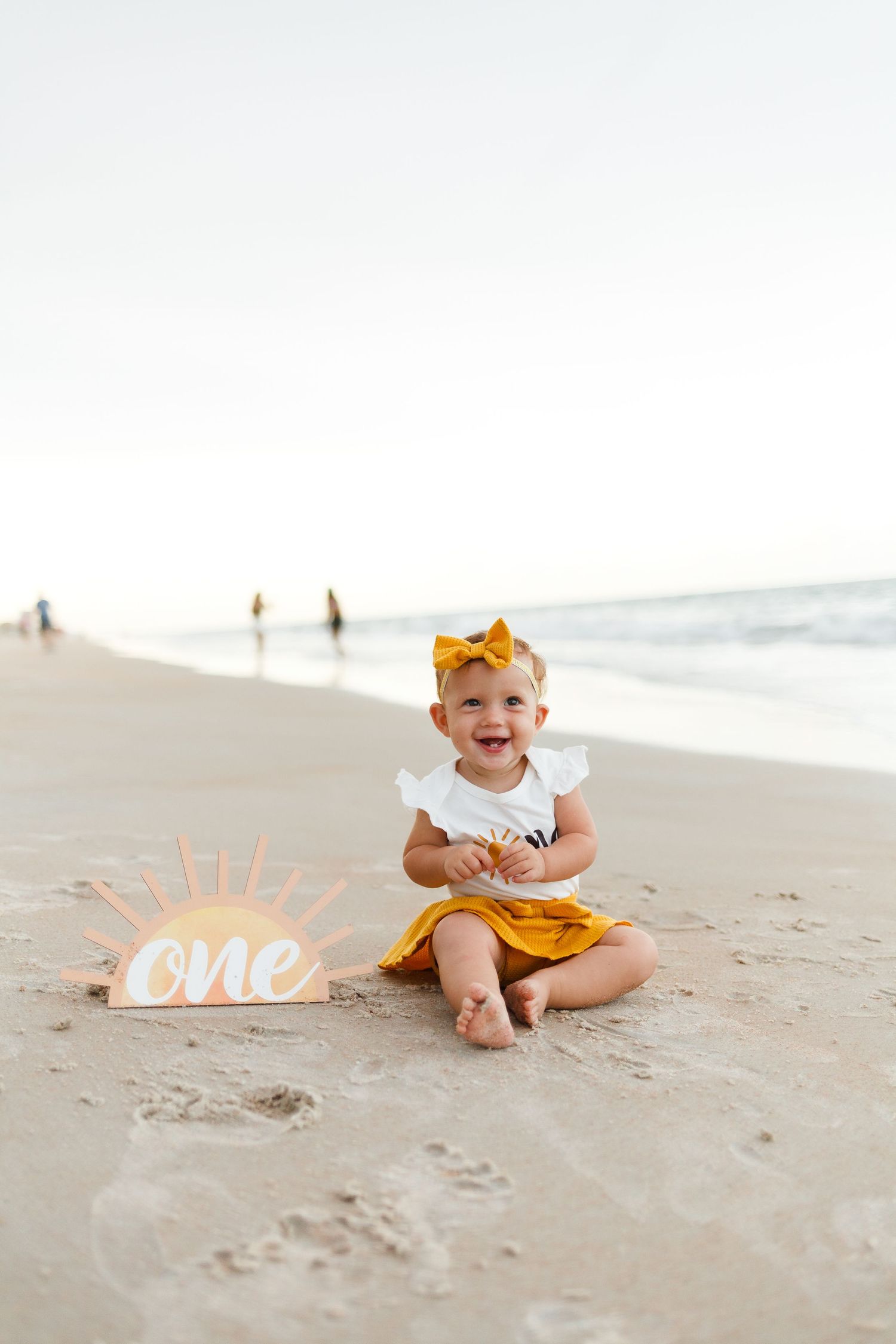 Baby's one year old birthday photoshoot on the beach. Milestone photoshoot session