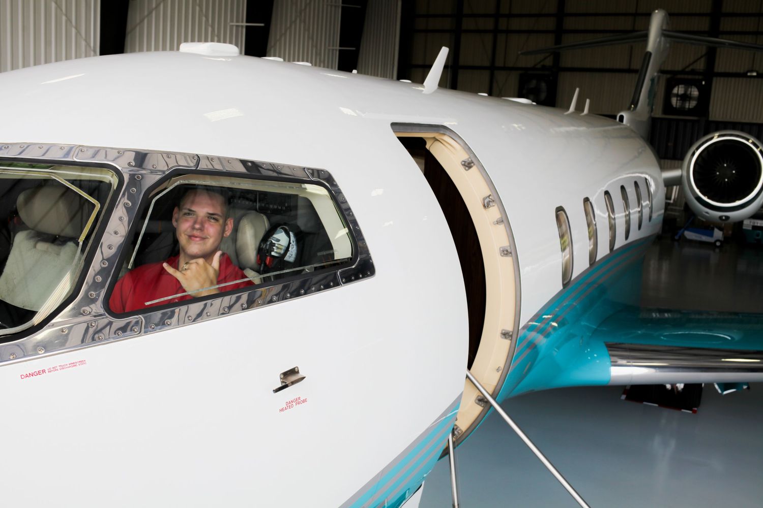 high school graduation photos. high school graduate posing with plane.