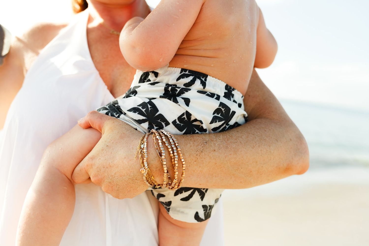 baby's first birthday photoshoot on the beach with surfboard