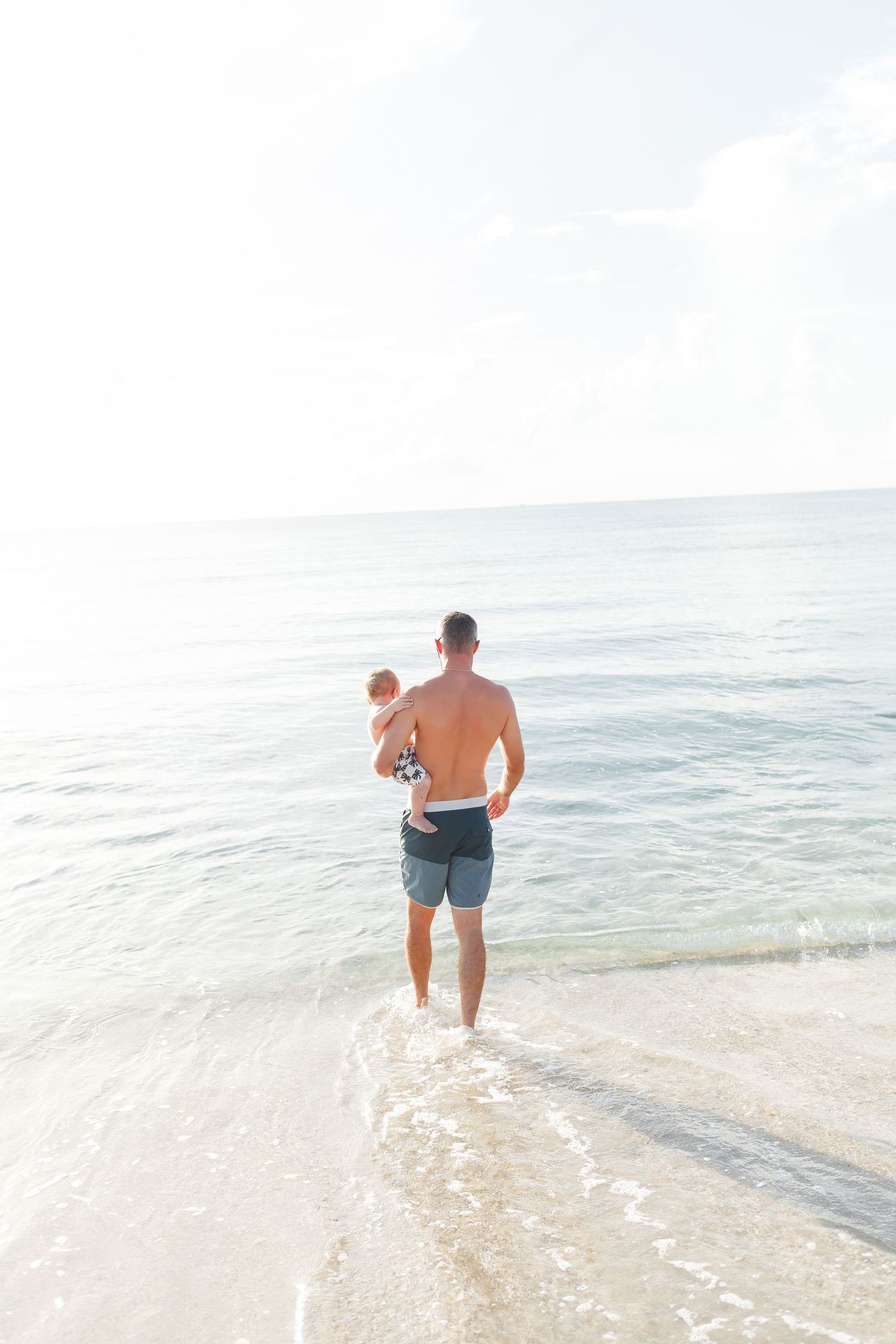 baby's first birthday photoshoot on the beach with surfboard