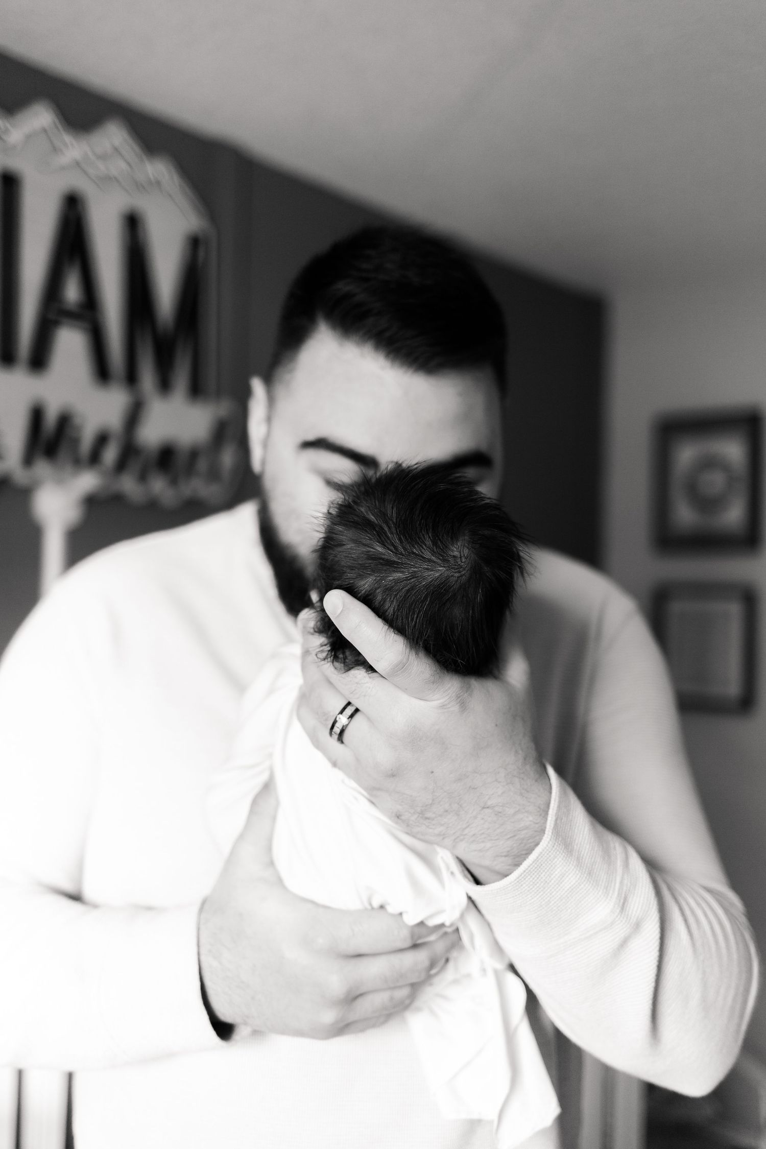 In home newborn photoshoot. Dad holding newborn baby photoshoot