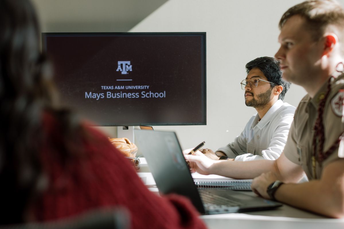 Students at Texas A&M Mays Business School attend a lecture with branded screen display.