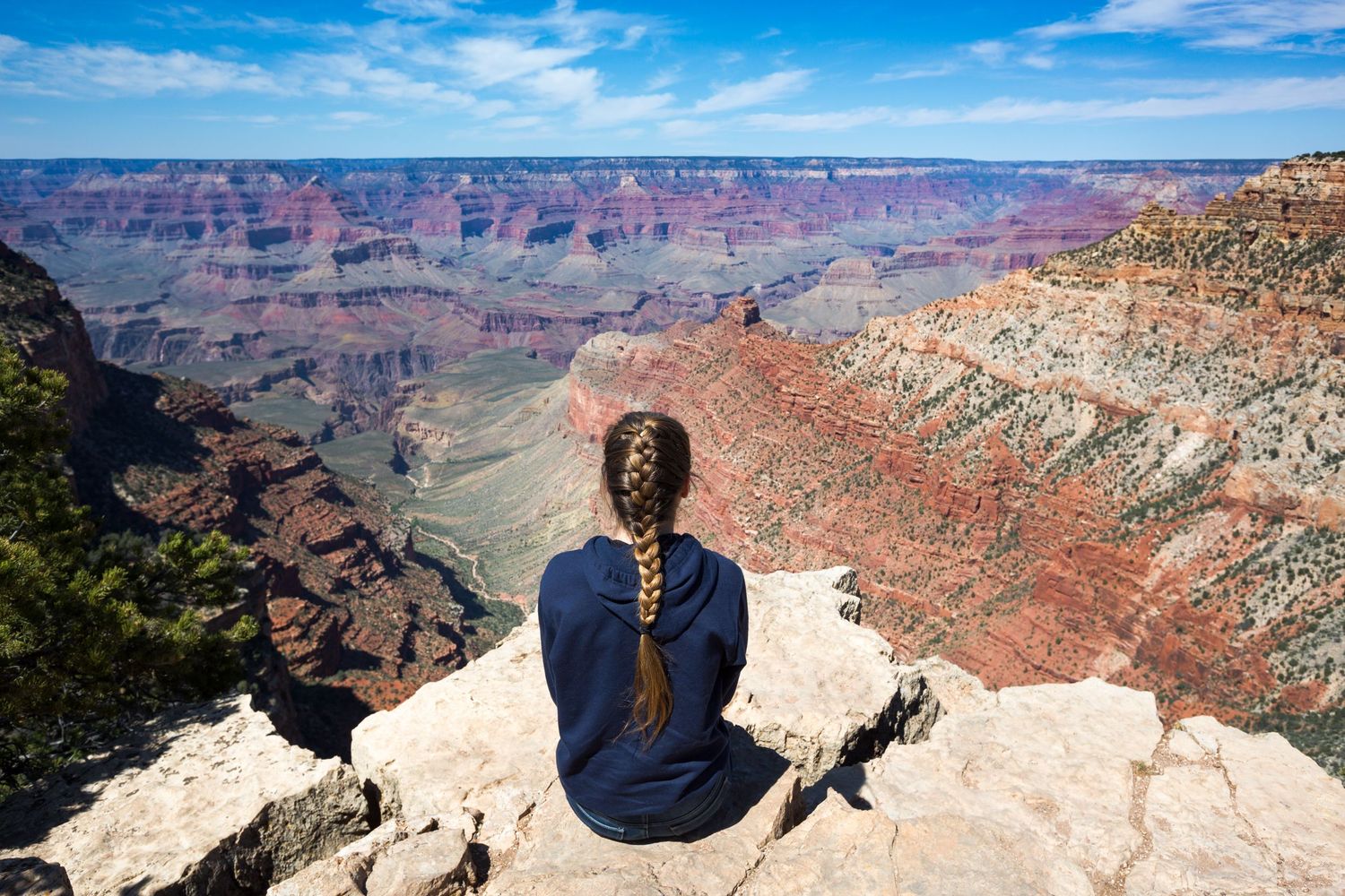 Quiet moment of contemplation overlooking Grand Canyon National Park in Arizona, where dramatic cliffs and open skies inspire reflection.