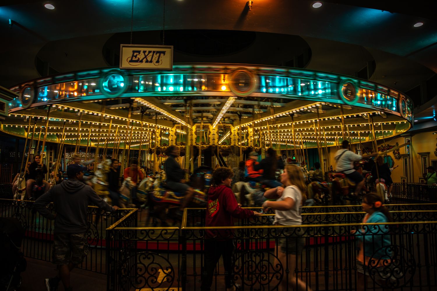 Long-exposure carousel spinning beneath glowing lights at the Santa Cruz Beach Boardwalk, capturing nostalgic motion and summer energy.