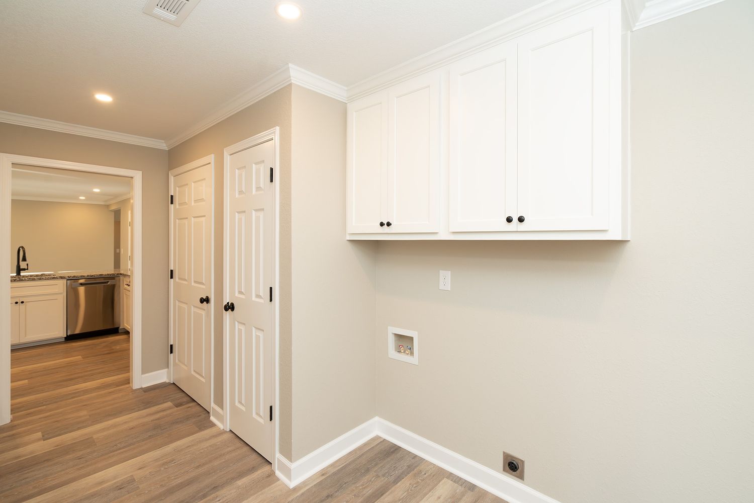 Laundry room with cabinets.