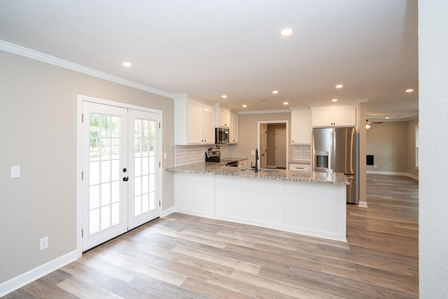 Large, renovated kitchen with stainless steel appliances.