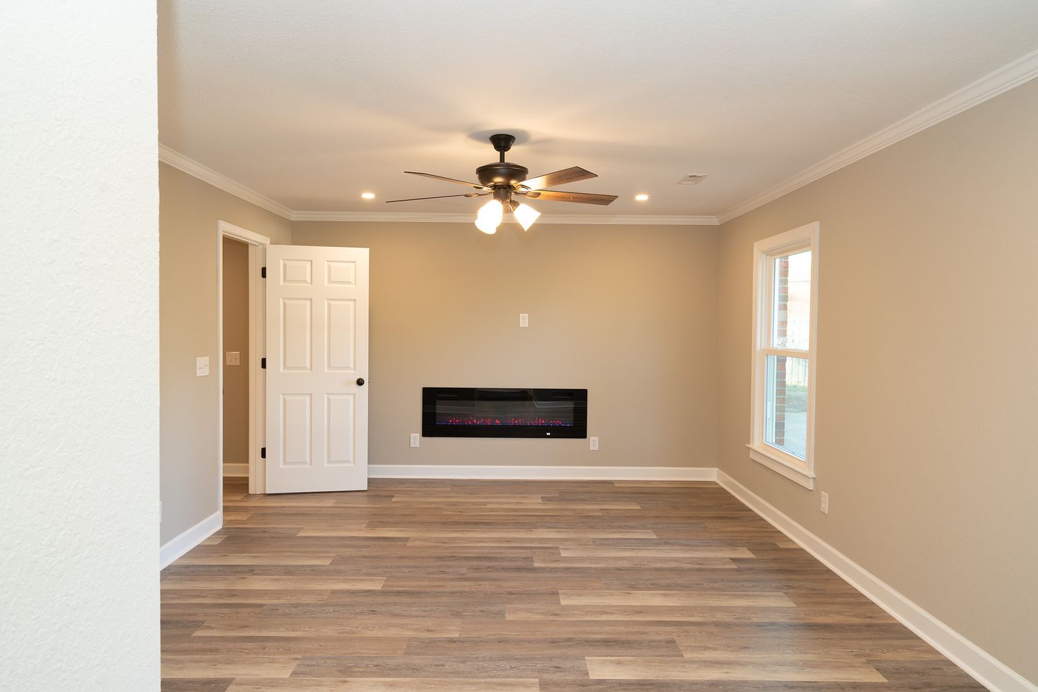 Living room with LVP and electric fireplace in Enterprise, Alabama.