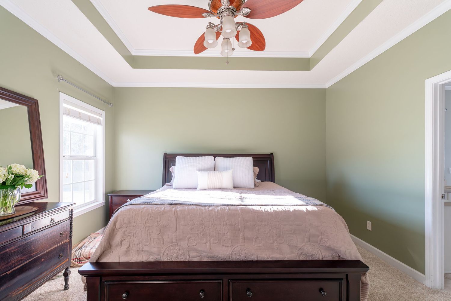 Large primary bedroom with ceiling fan in Dothan.