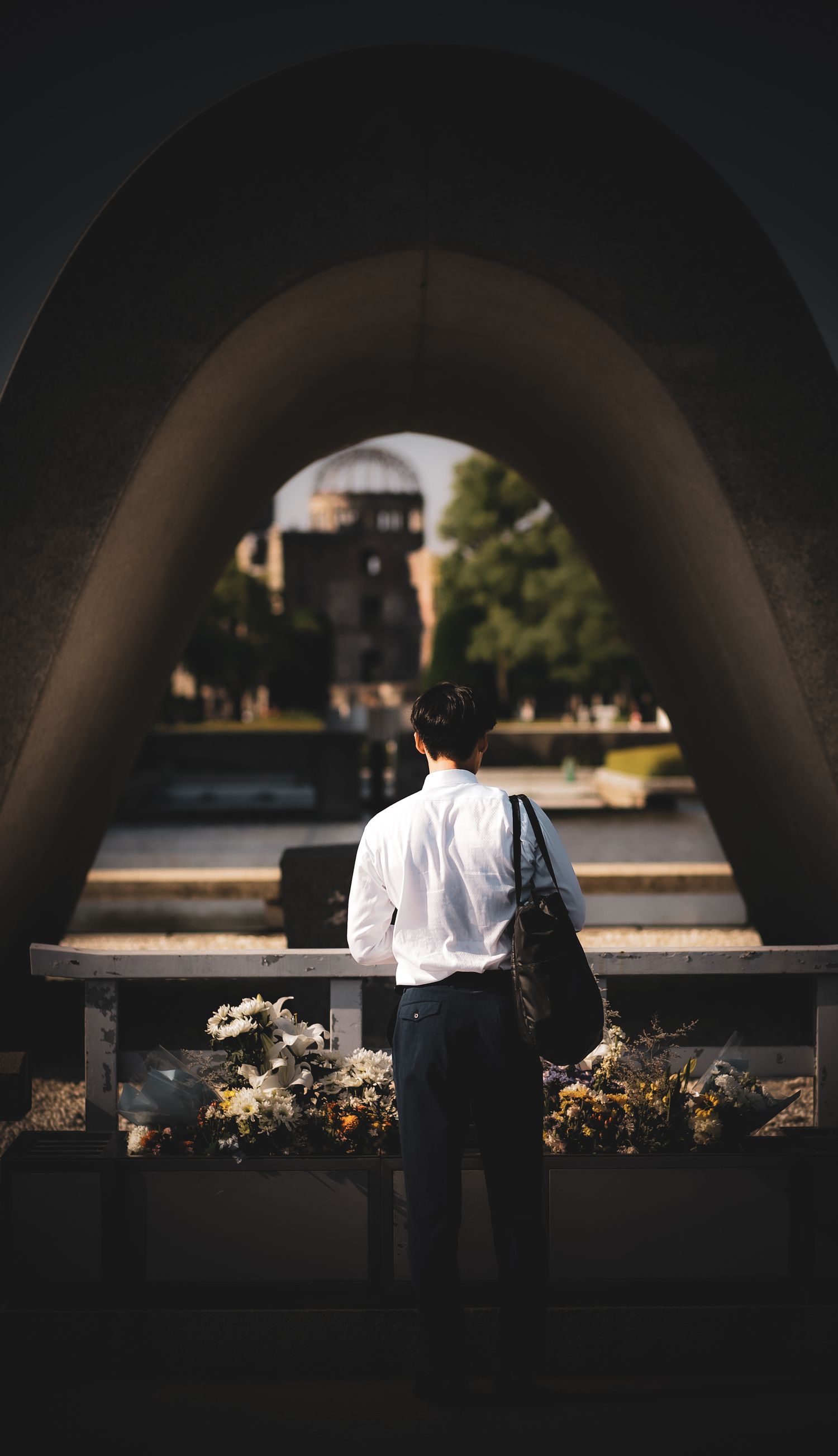 A man standing in contemplation at the peace museum memorial in Hiroshima
