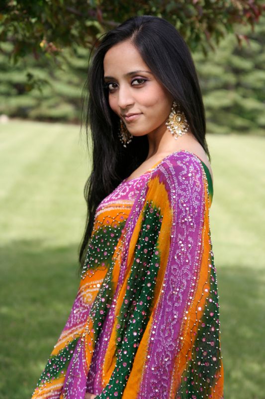 Photo of a young woman smiling demurely at the camera.