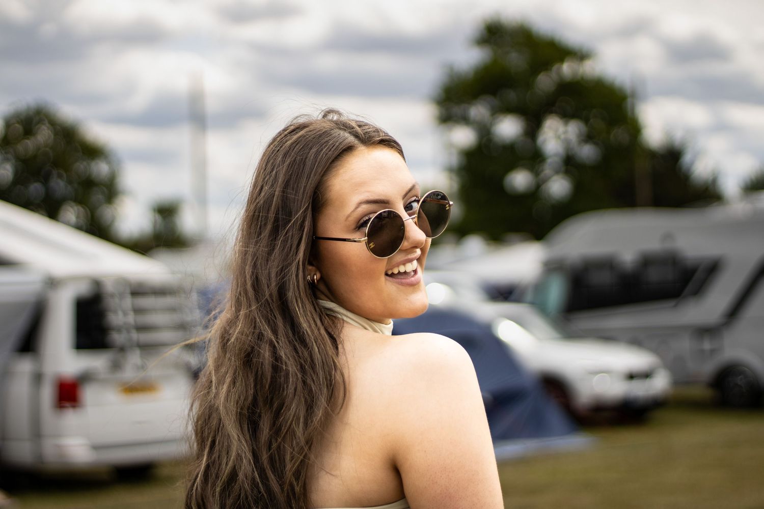 Summer portrait series outdoors with sunglasses and natural lighting.
