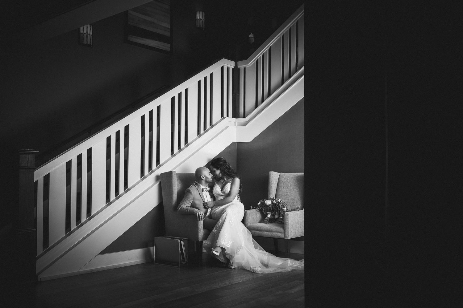 Black and white artistic photo series showing a cat walking up white stairs in four sequential frames.