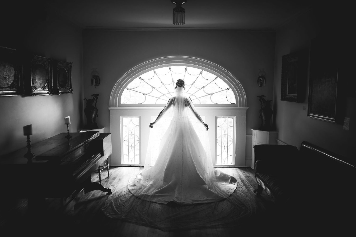 Dramatic silhouette shots of bride in wedding dress against bright window light.