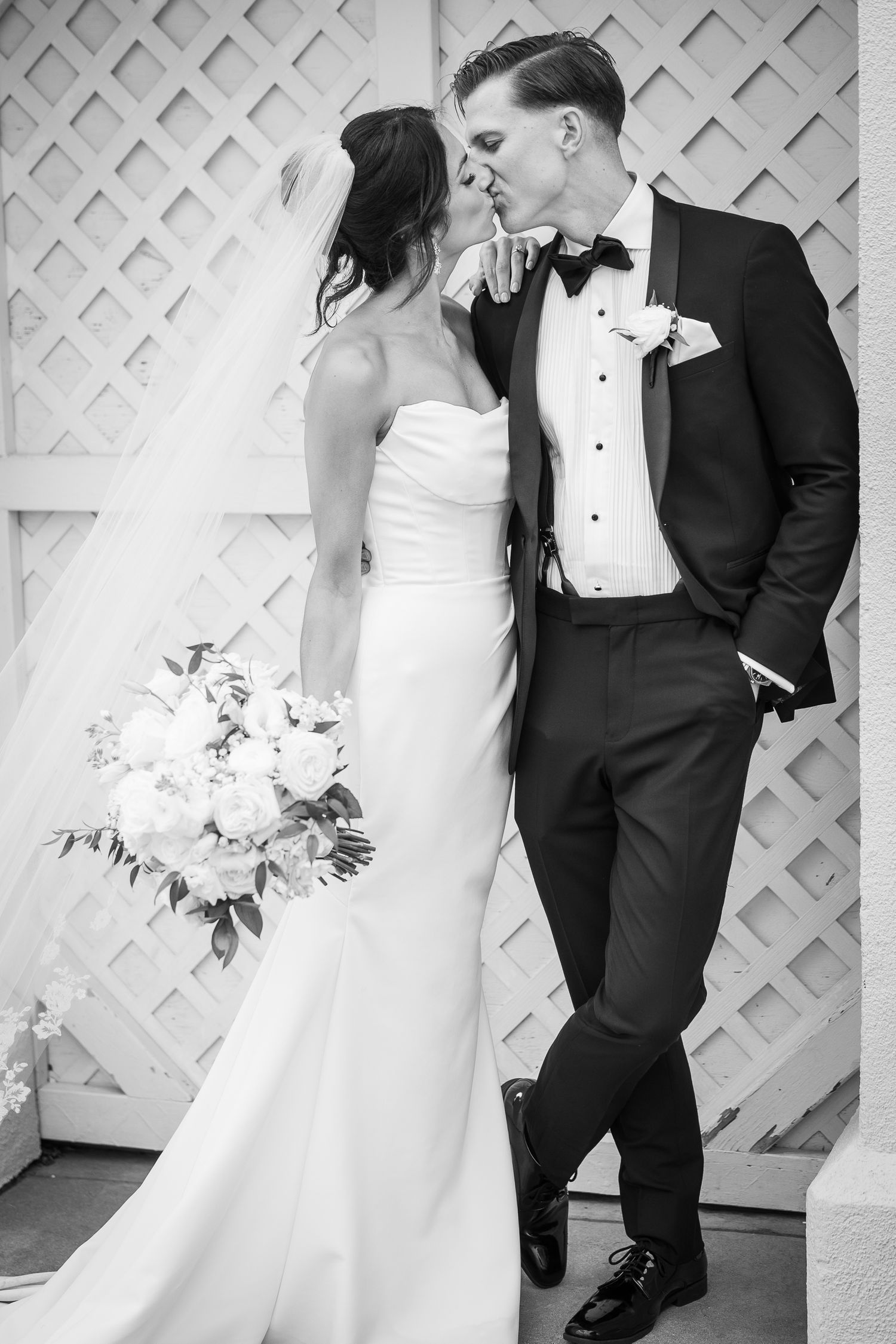 Romantic wedding couple poses against white lattice backdrop in sequence.