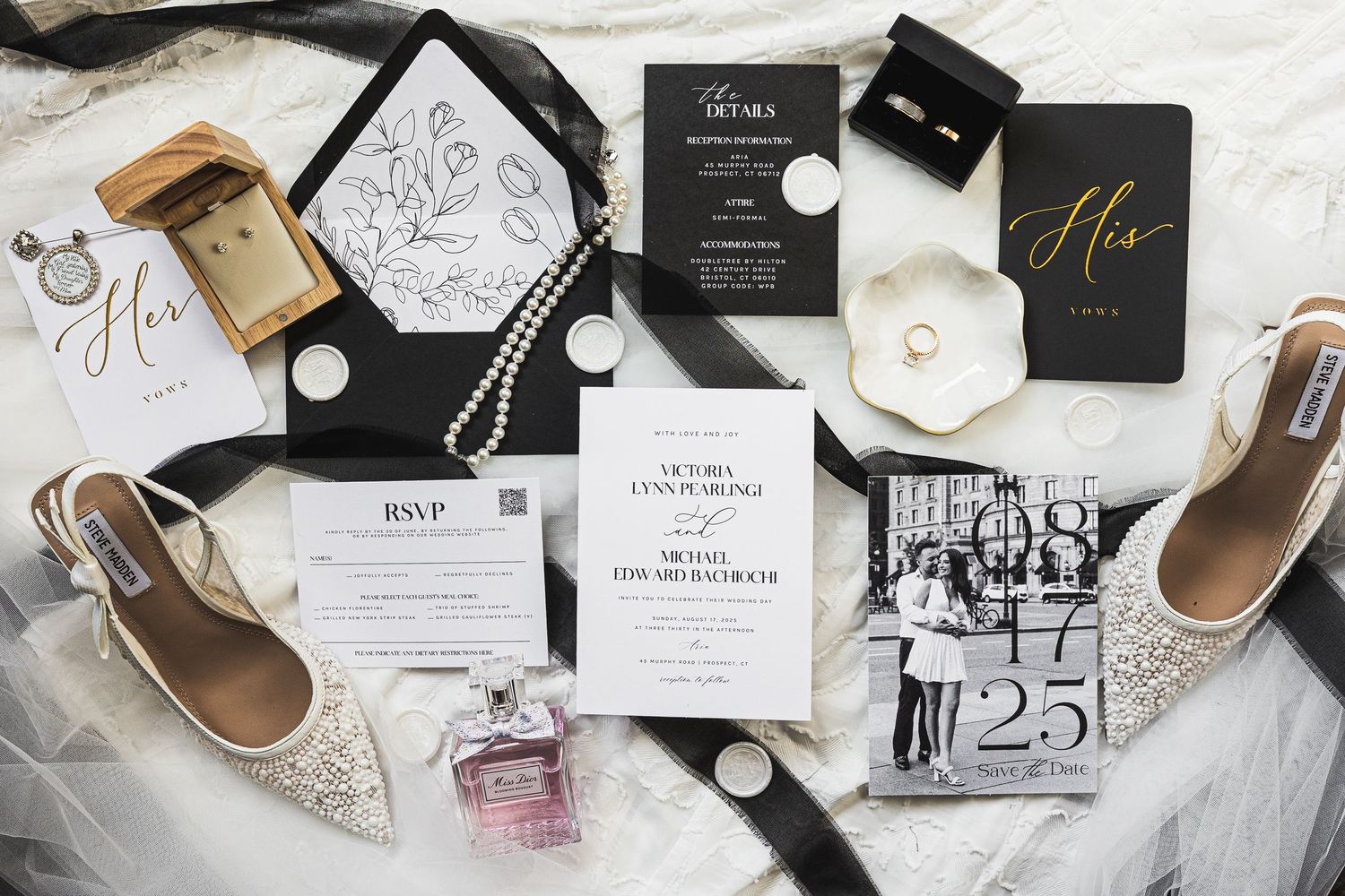 Elegant wedding details including invitations, shoes, and accessories arranged on white surface.
