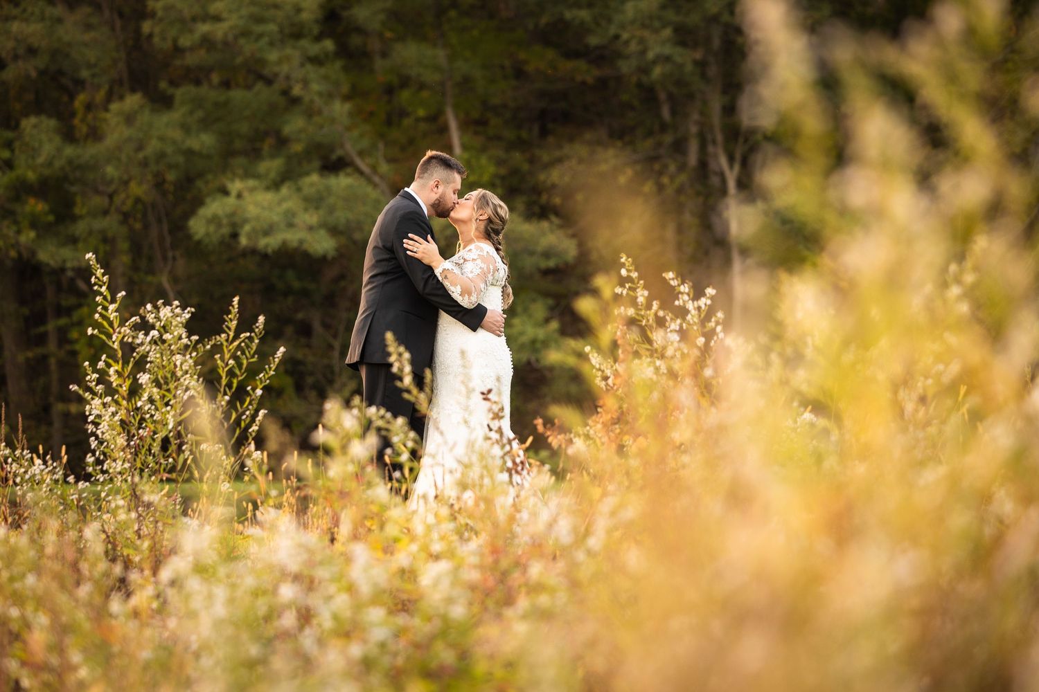Romantic outdoor portrait in golden field during sunset.