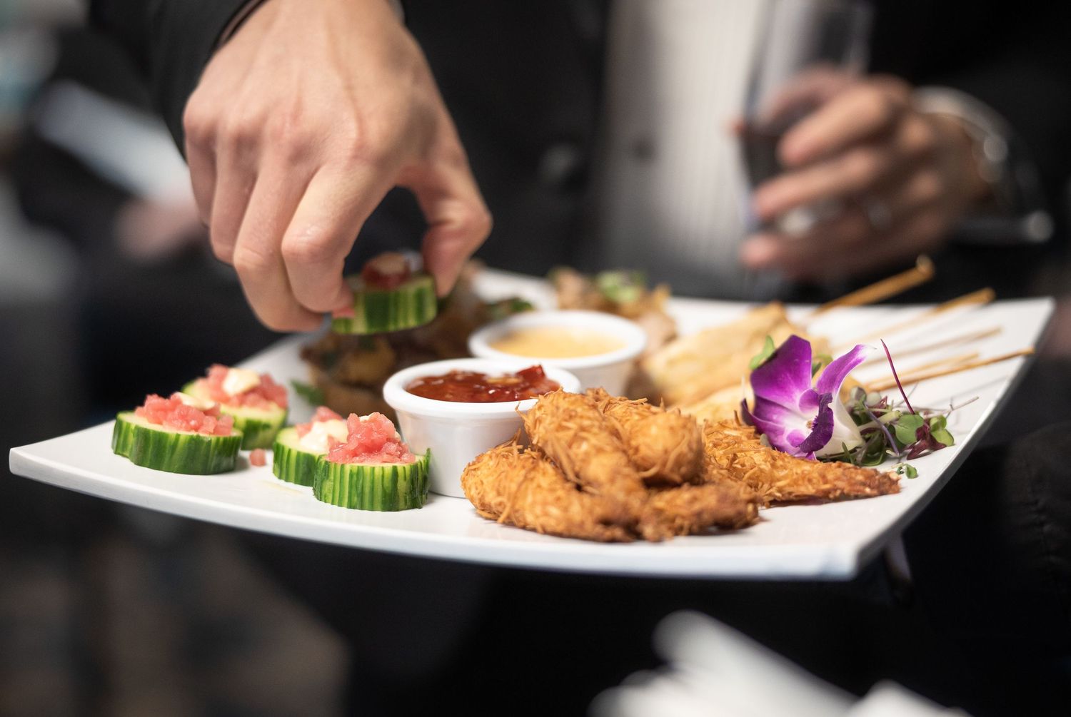 Close-up of plated gourmet wedding reception meals being served.