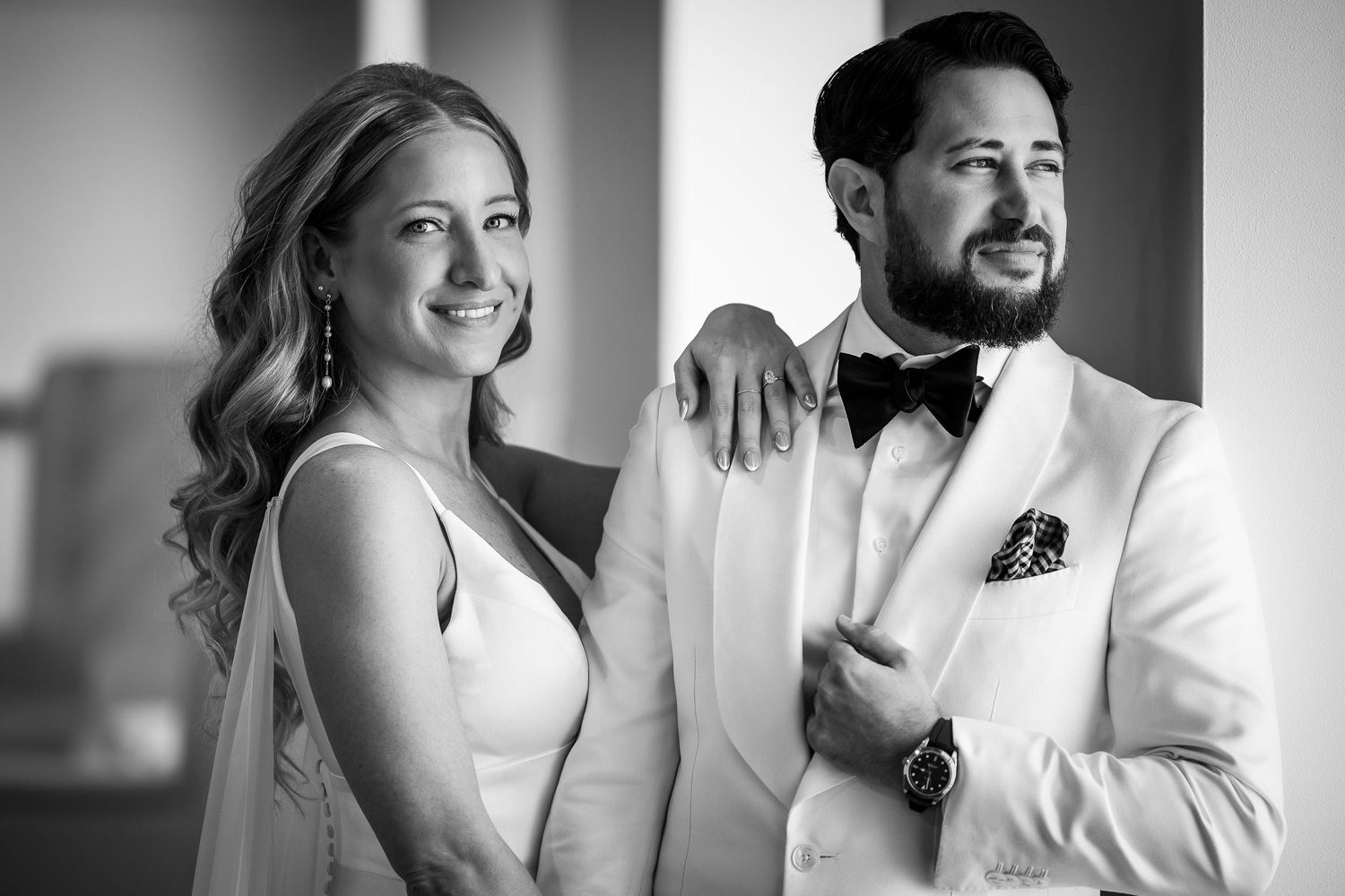 A collection of black and white wedding portraits showing candid romantic moments between a bride and groom.