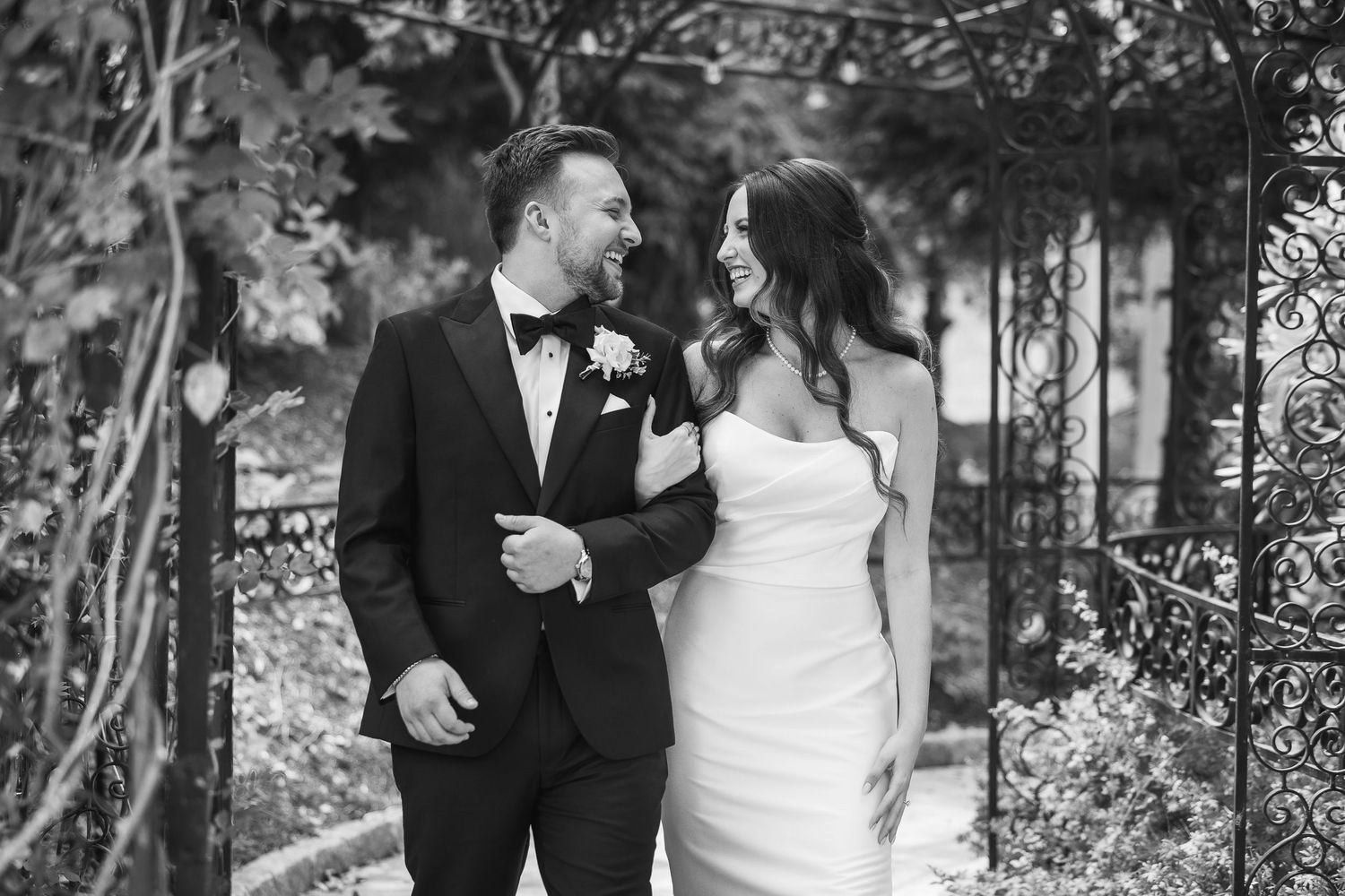 Romantic black and white wedding photos showing intimate moments between a couple in an outdoor garden setting.