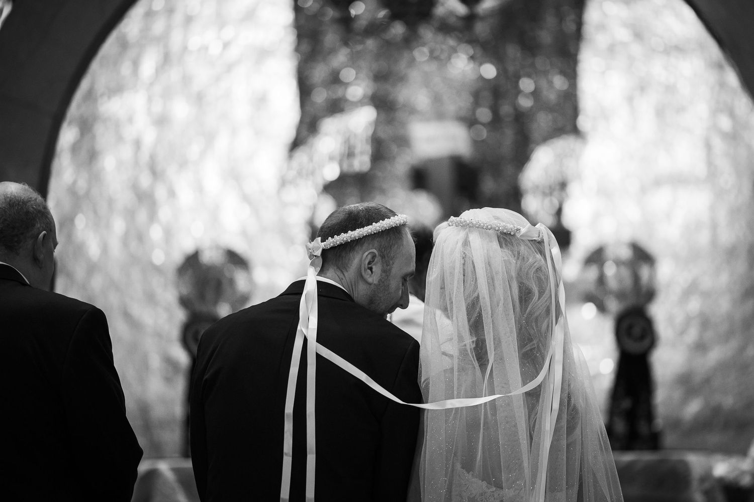 Black and white ceremony photo with soft focus and dramatic lighting.