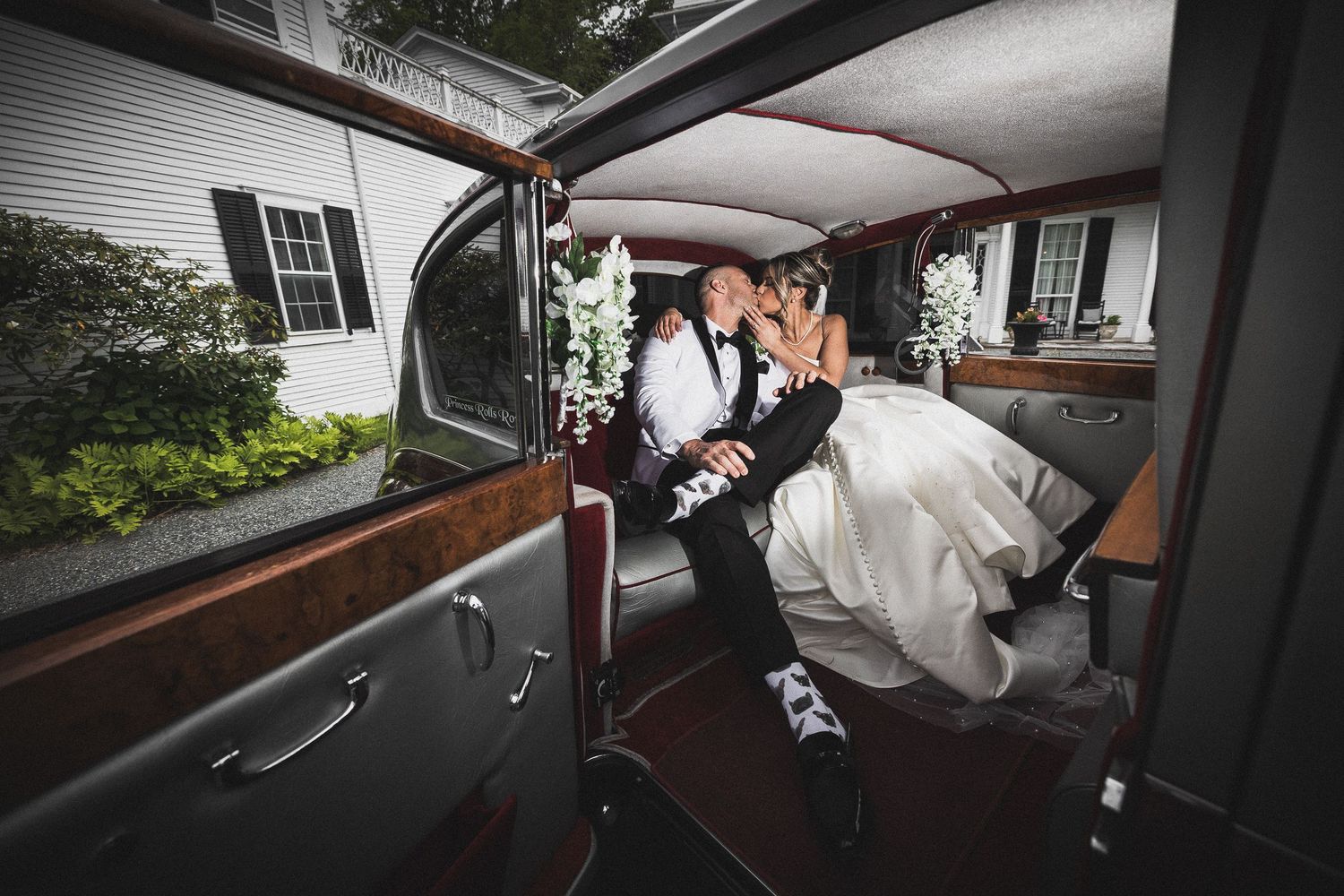 Black and white photo showing the interior details of a classic car at a wedding.