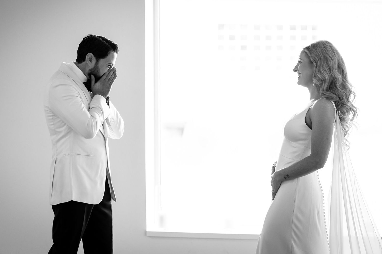 A romantic black and white photo series showing intimate moments between a couple on their wedding day.