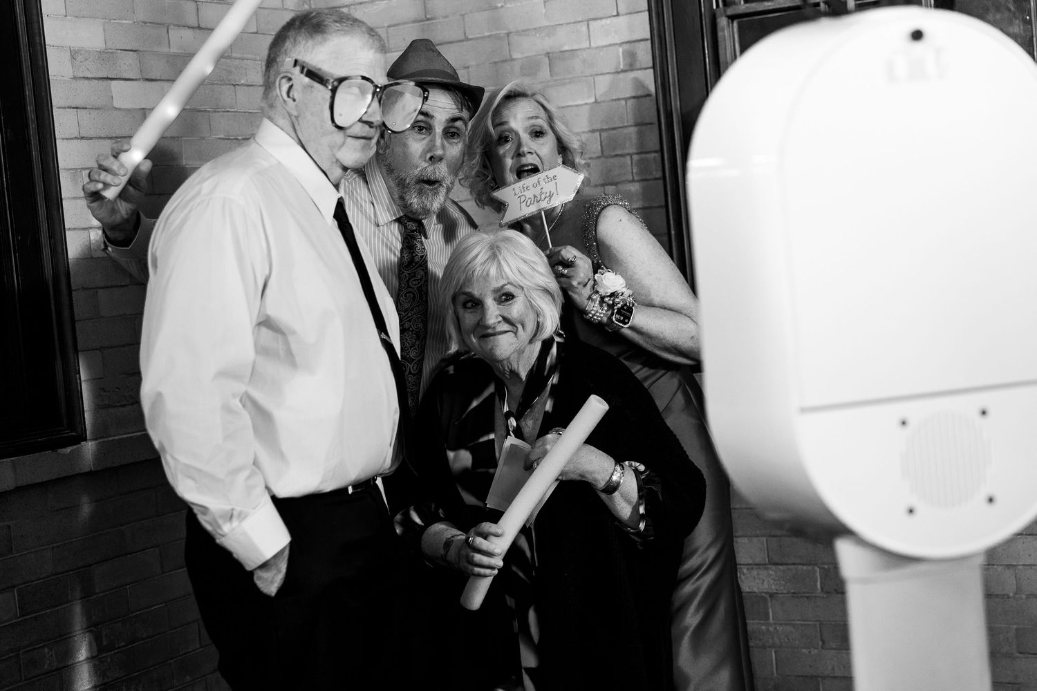 Black and white photo series showing candid moments at a wedding celebration.