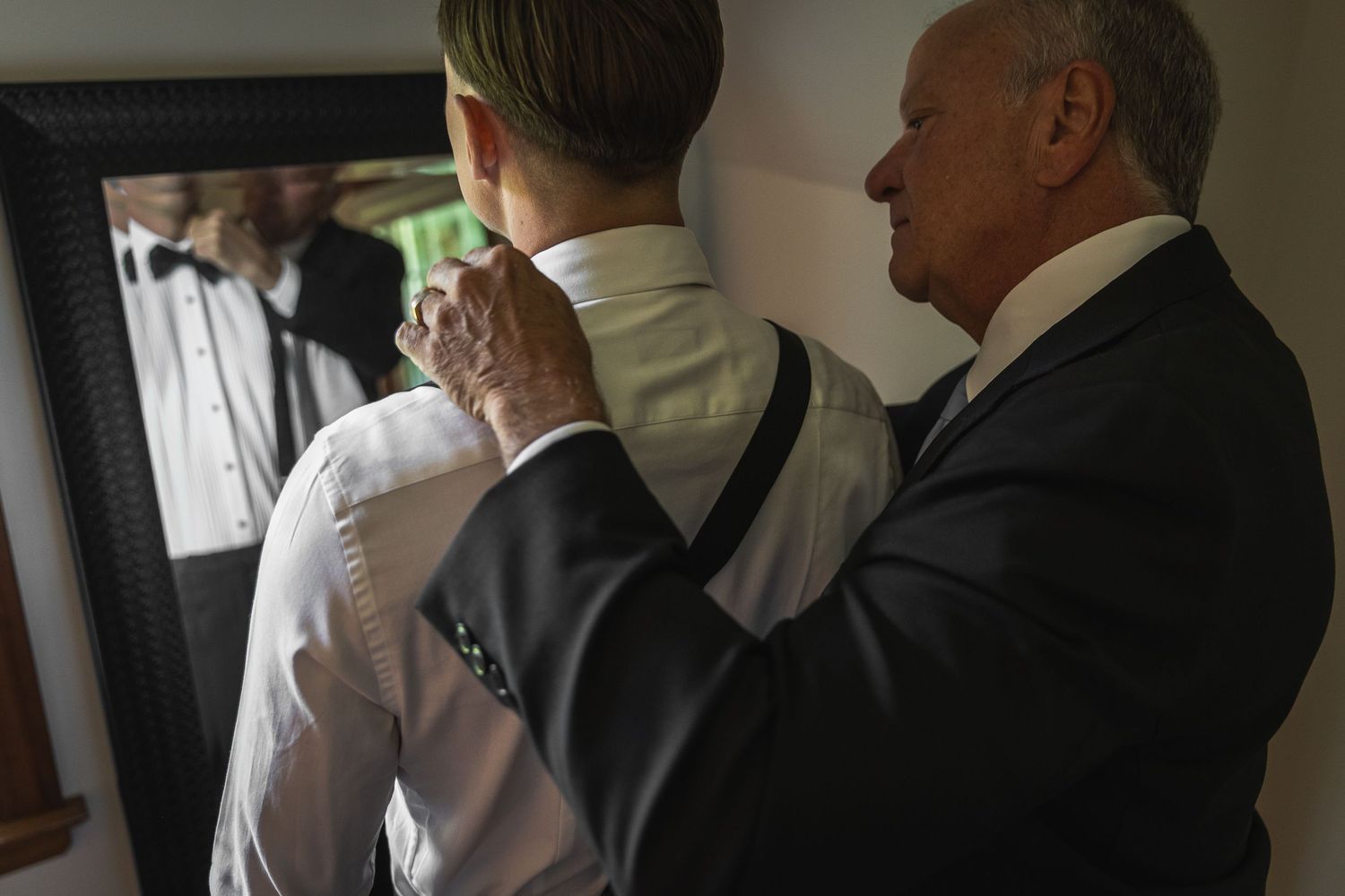 Getting ready moment as formal attire is adjusted before the ceremony.