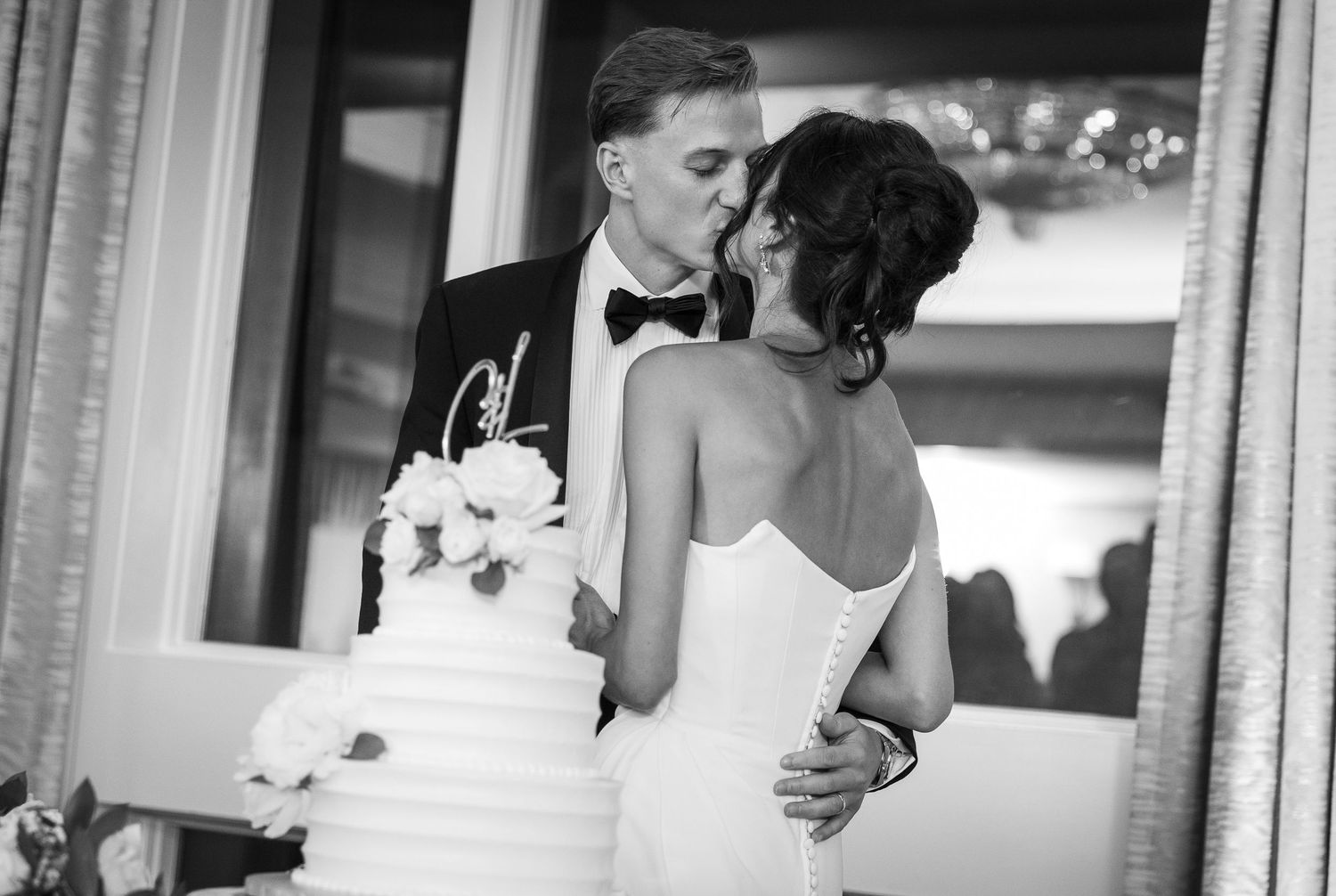 Black and white wedding reception details with cake and decor.