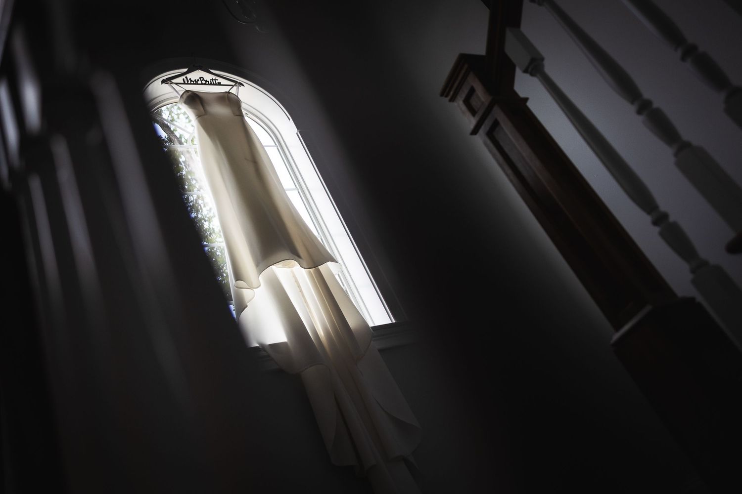 Diagonal beams of sunlight cast dramatic shadows through architectural elements.