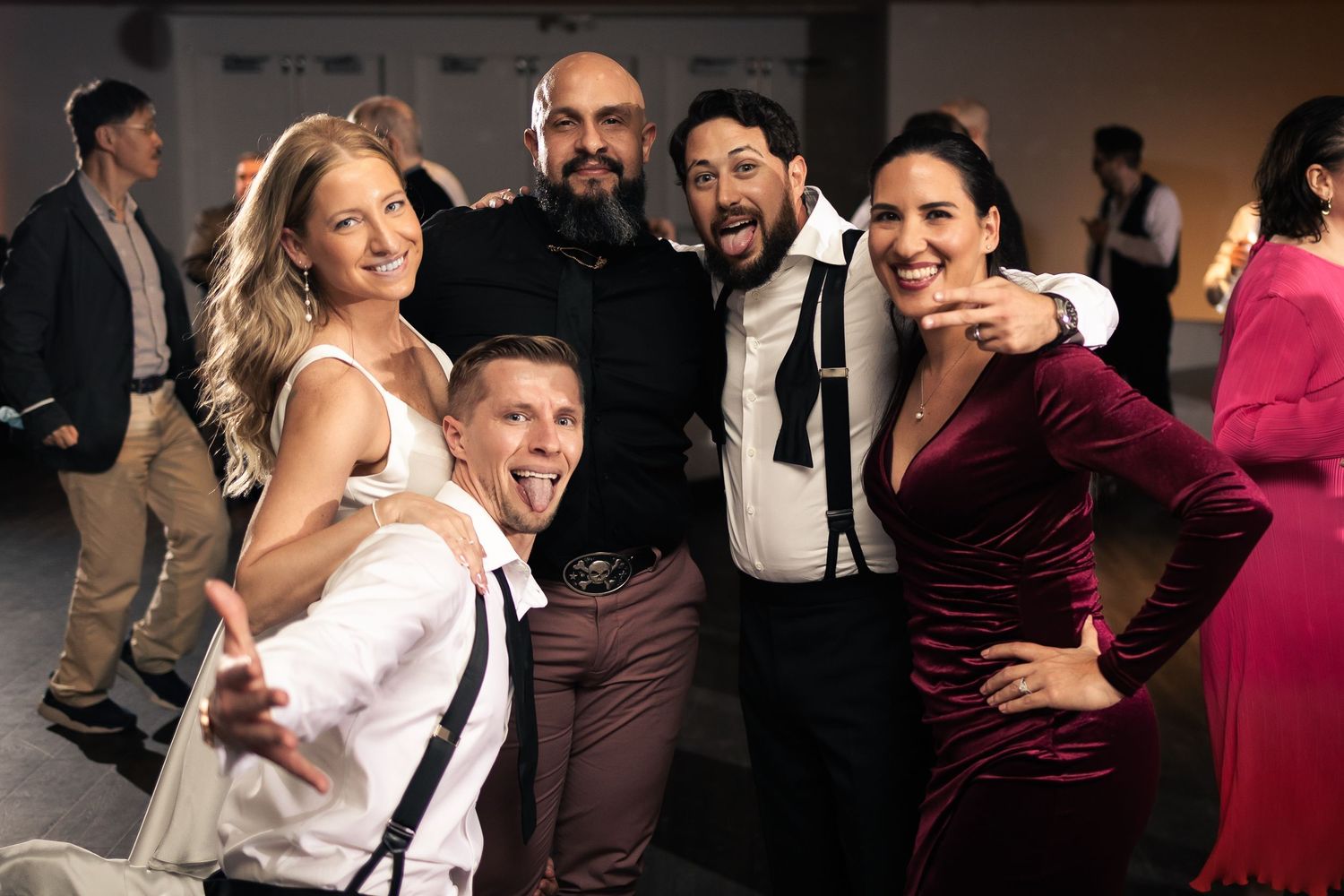 A sequence of candid dance floor moments at a wedding reception showing couples dancing and celebrating together.