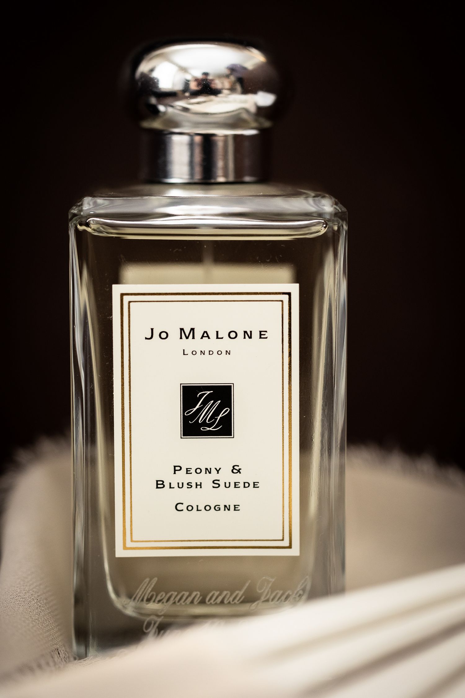 Jo Malone London perfume bottles arranged in an elegant display with soft lighting.
