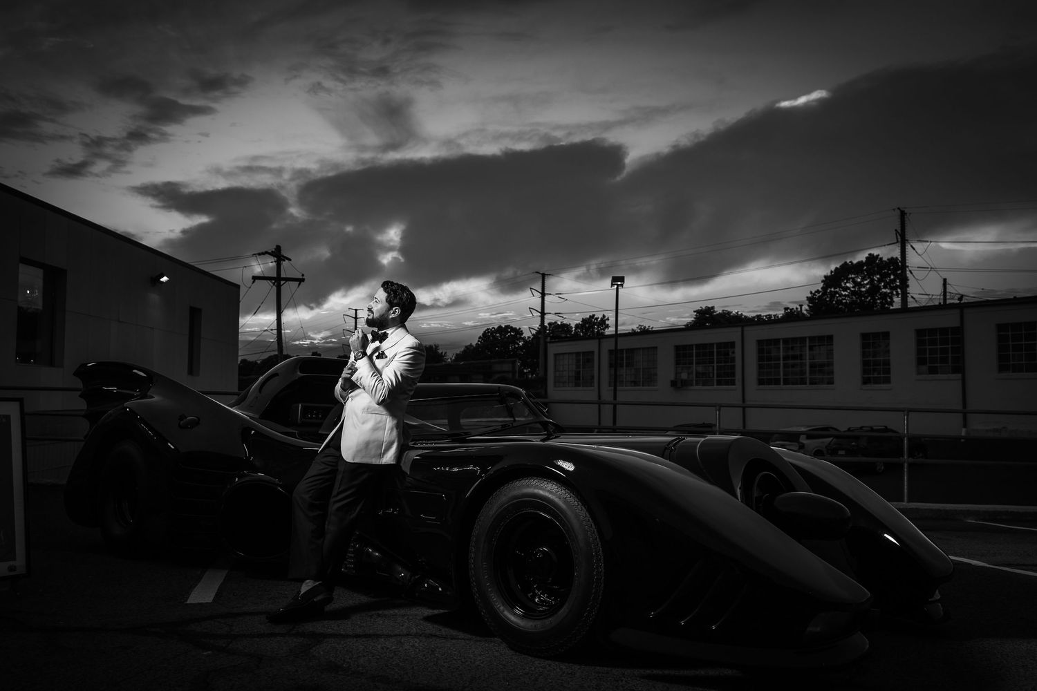 A dramatic black and white photo sequence showing a vintage race car flipping and crashing during a motorsport event.