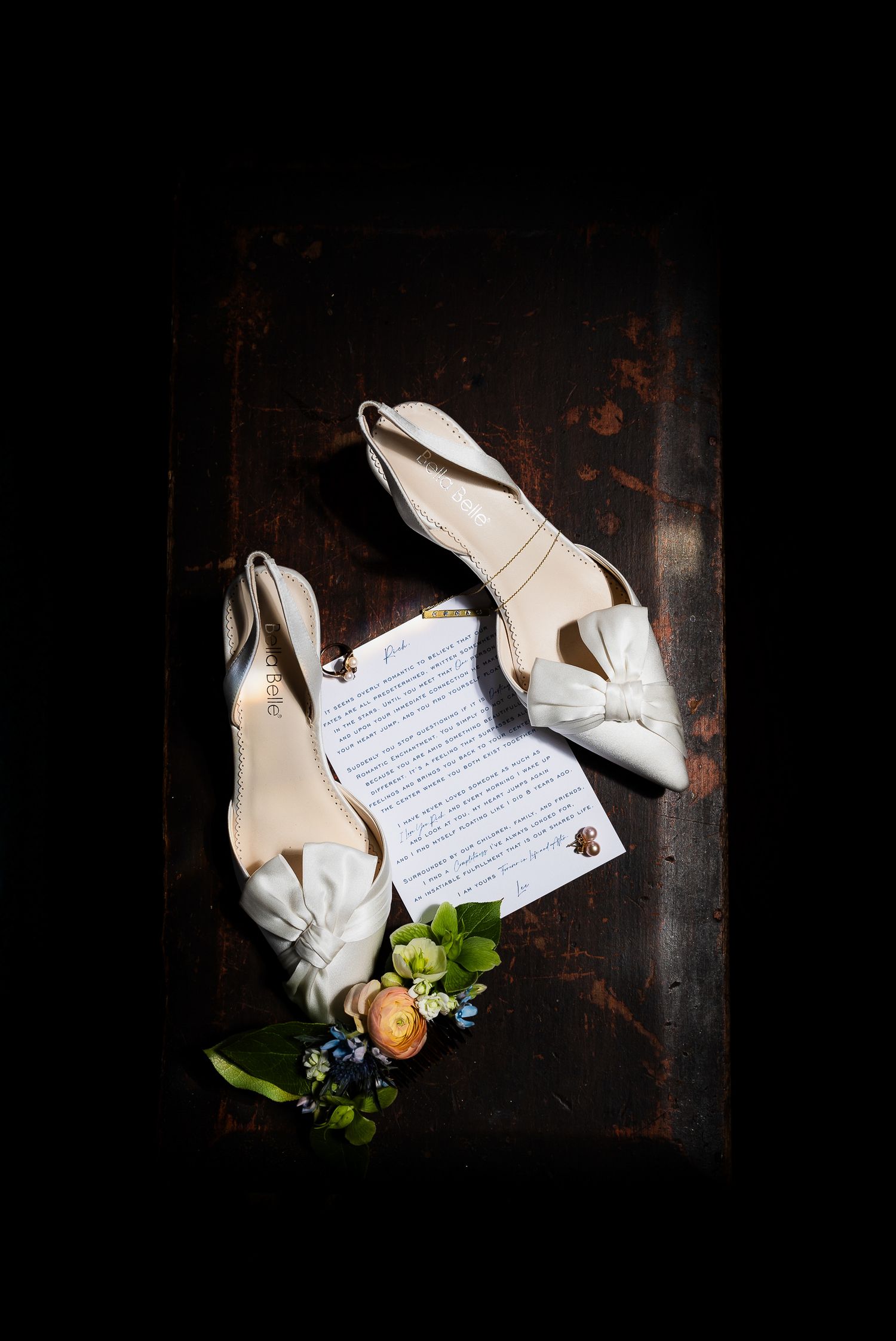 A series of white wedding shoes photographed with floral elements and handwritten notes against a dark background.