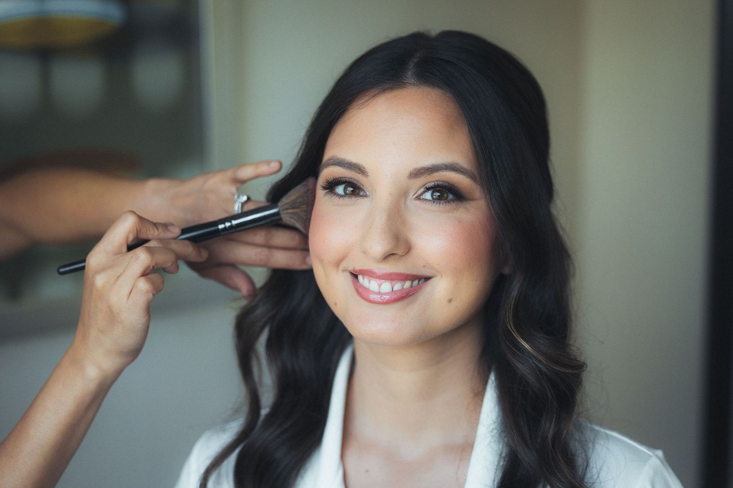 Getting ready sequence showing makeup application in natural window light.