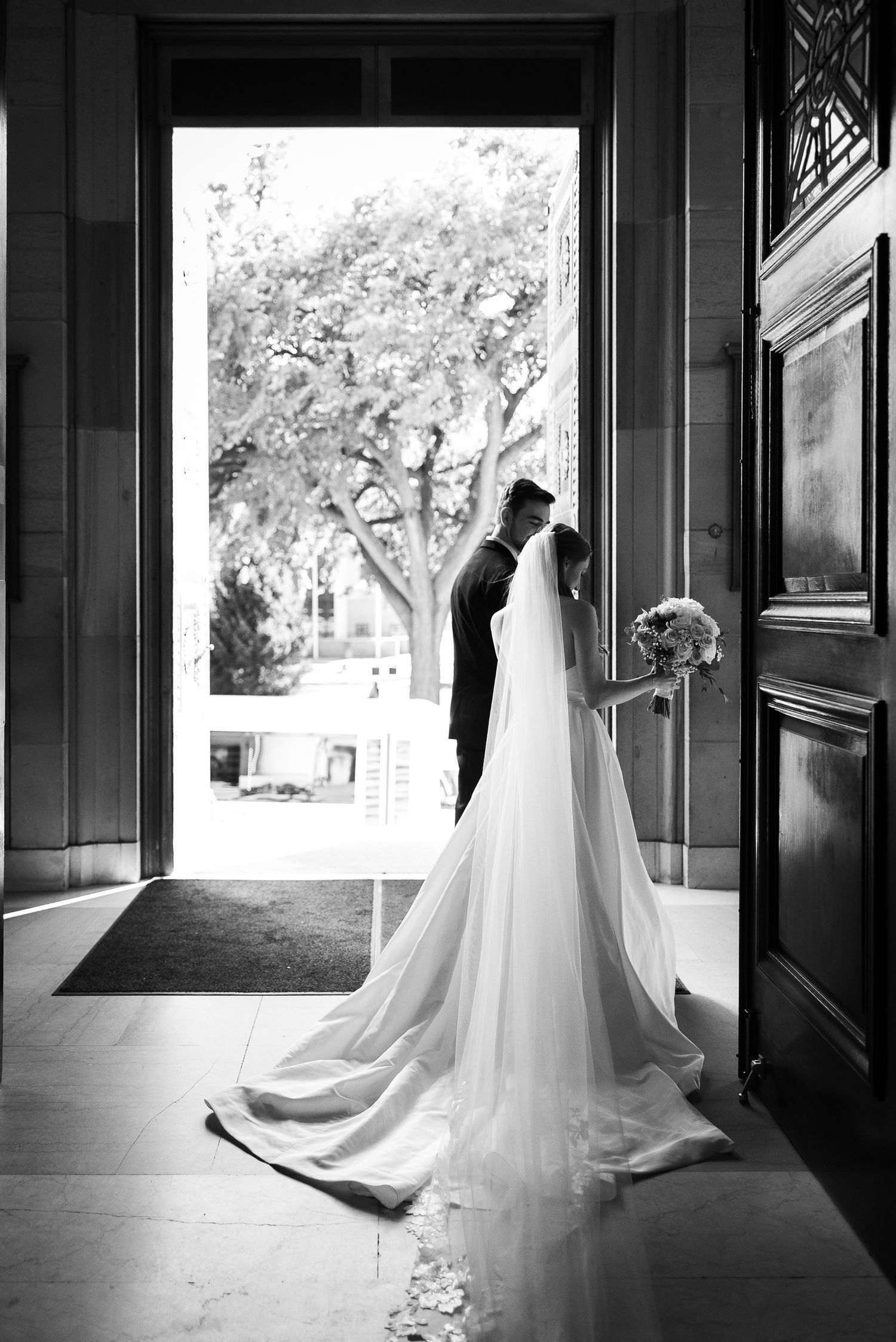 A series of black and white photographs showing elegant wedding dresses hanging in doorways with natural light streaming in.