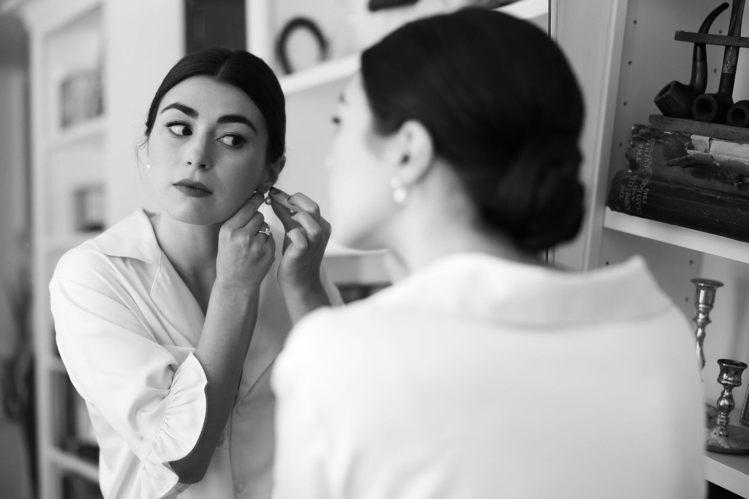 Getting ready scene with makeup application in natural window light.