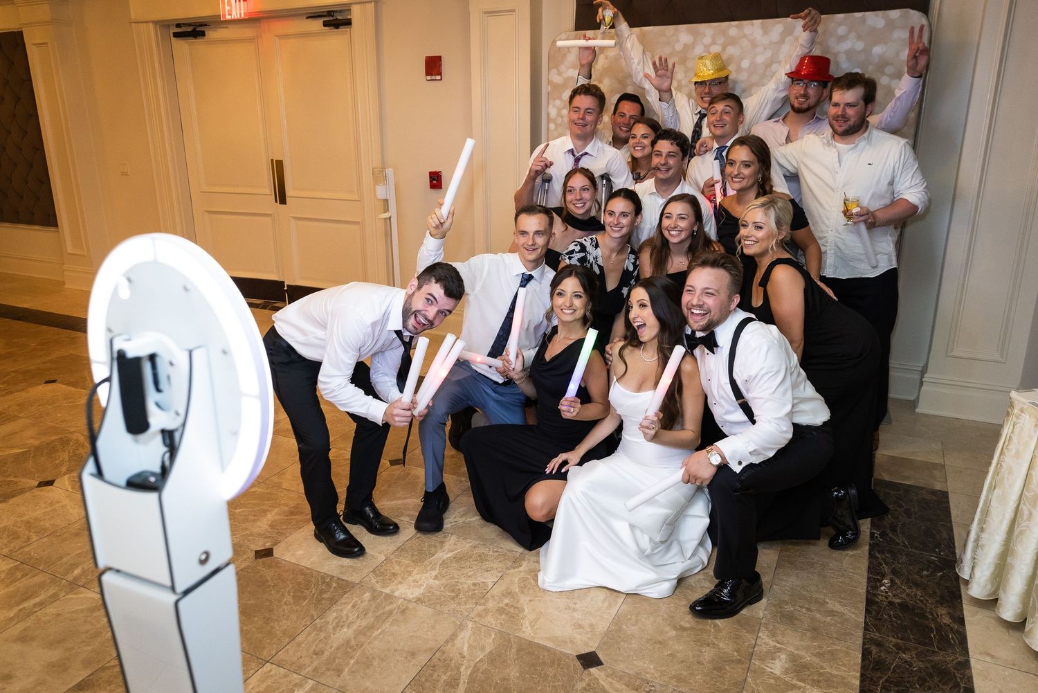 Wedding guests celebrating and posing together for group photos indoors.