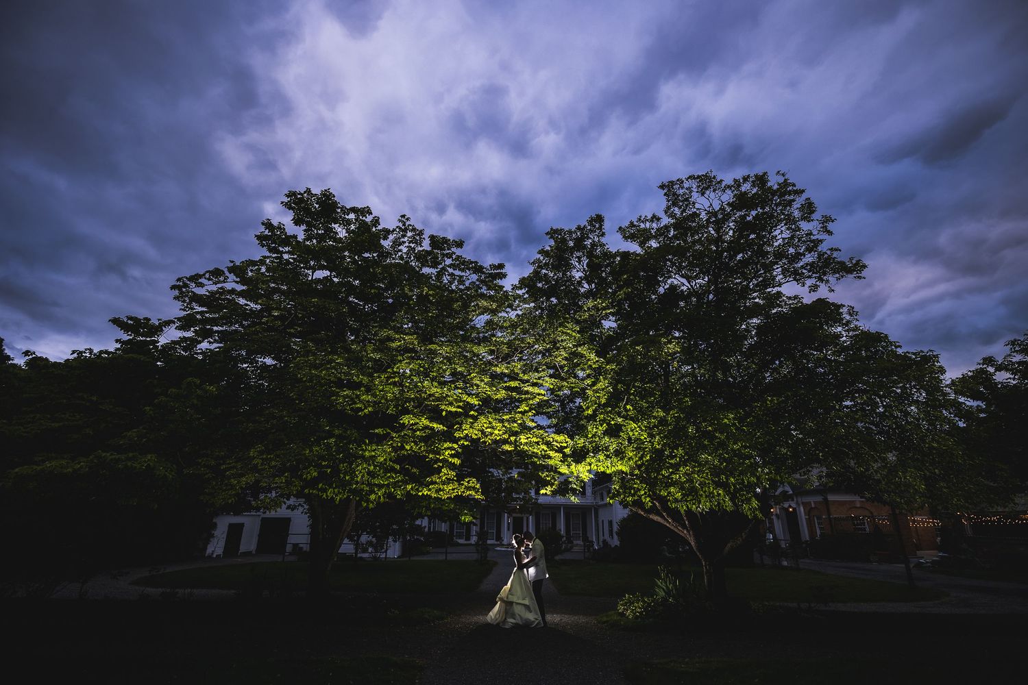 Moody sunset sky with dramatic clouds and silhouetted trees.